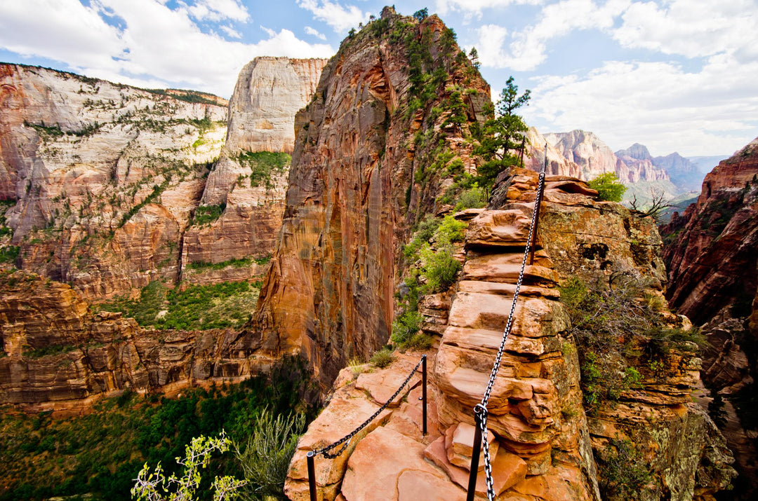 A hiking trail at Angels Landing in Zion National Park with a steep climb up a red rock formation.