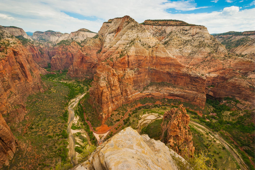 A scenic view of the rugged landscape of Zion National Park with the Virgin River winding through the valley.