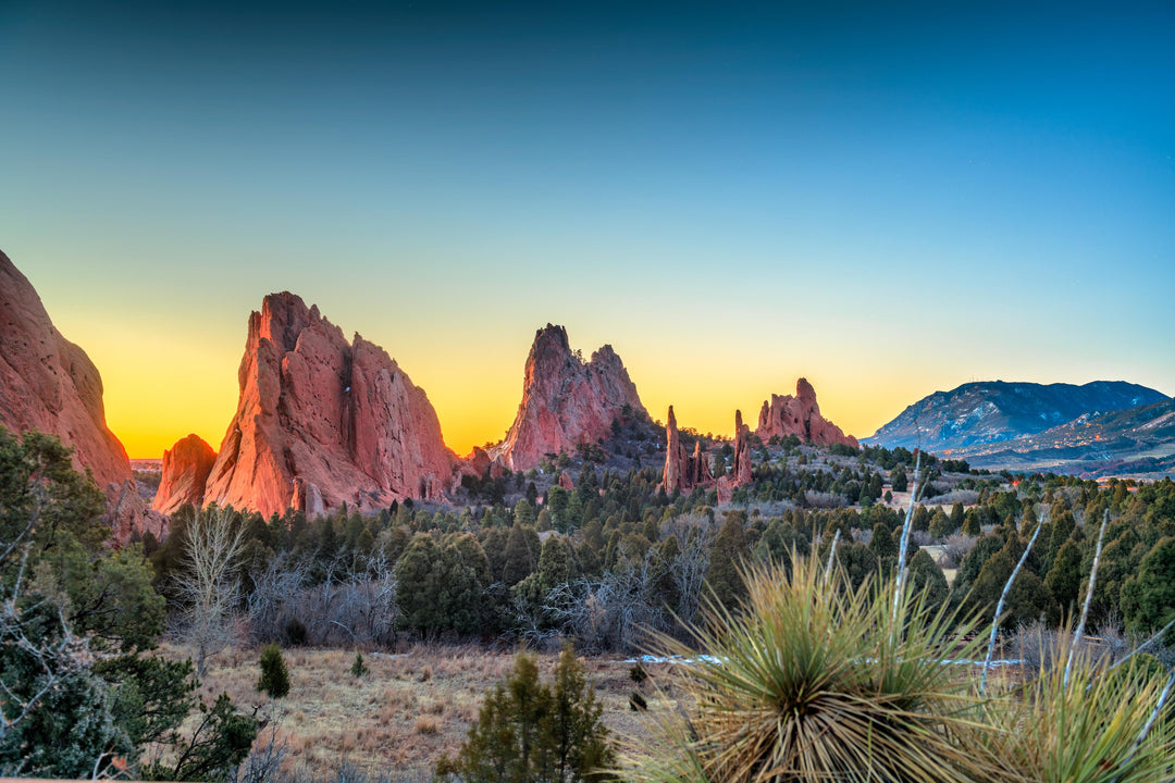 Sunset at Garden of the Gods, Colorado, with red rock formations and a clear sky.