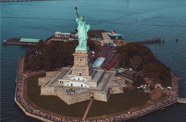 Aerial view of the Statue of Liberty, Liberty Island, with the ocean in the background.