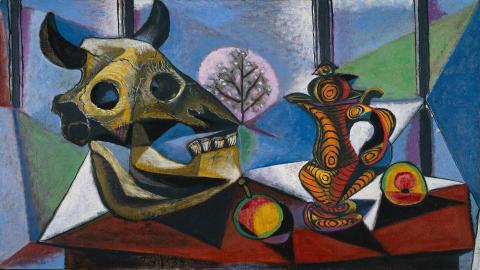 Abstract artwork with a bull's head sculpture and colorful vase on a table.