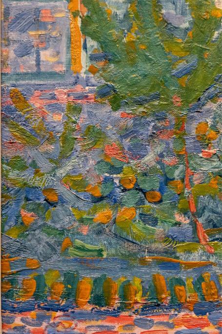 A detail of an abstract painting featuring geometric patterns with predominantly blue and orange colors.