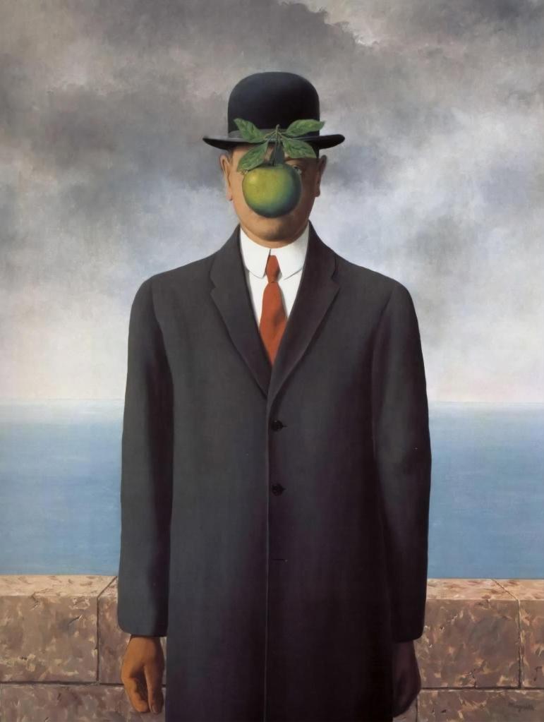 A man in a suit and bowler hat stands by a low wall overlooking the sea. His face is obscured by a floating green apple, creating a surreal, enigmatic tone.
