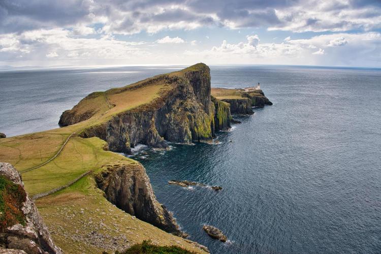 Scenic view of a coastal landscape with cliffs and ocean.