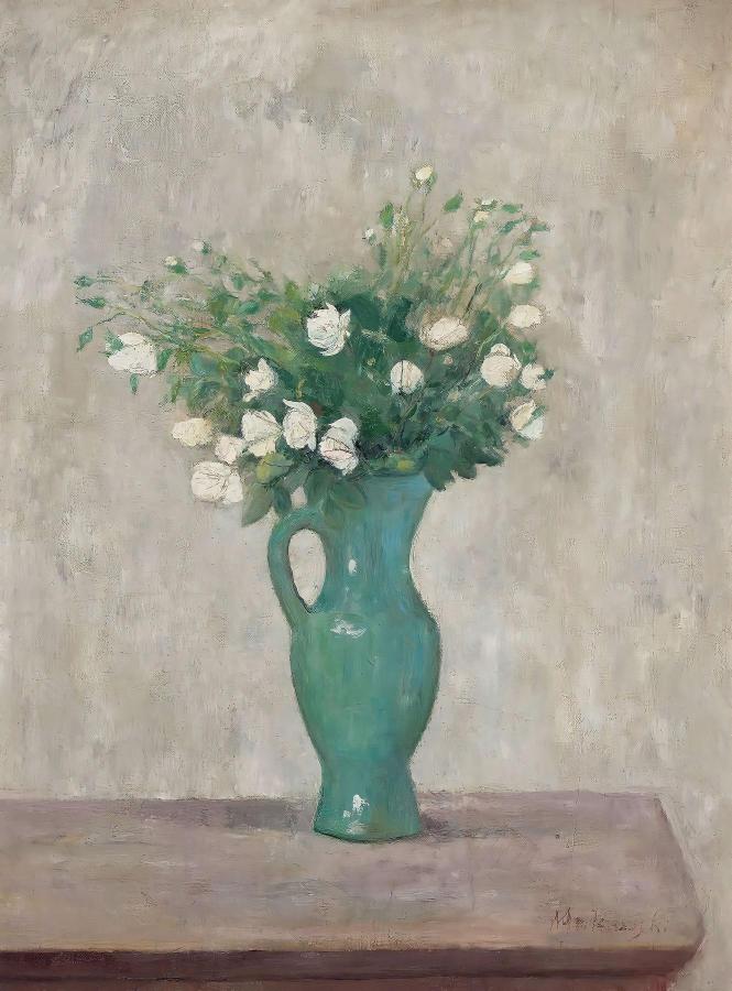 A green vase with white flowers sits on a wooden table against a muted backdrop. The scene is serene and minimalist, conveying calm and simplicity.