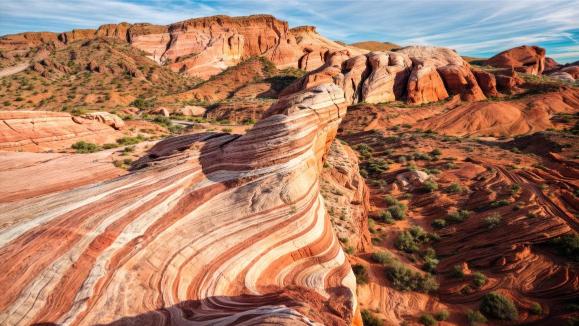 A landscape photo of the Valley of Fire with its characteristic sandstone formations under a blue sky.