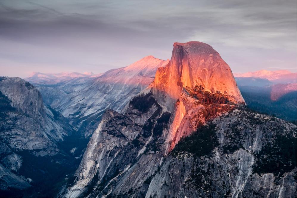 Sunset illumination on Half Dome mountain in Yosemite National Park, California.