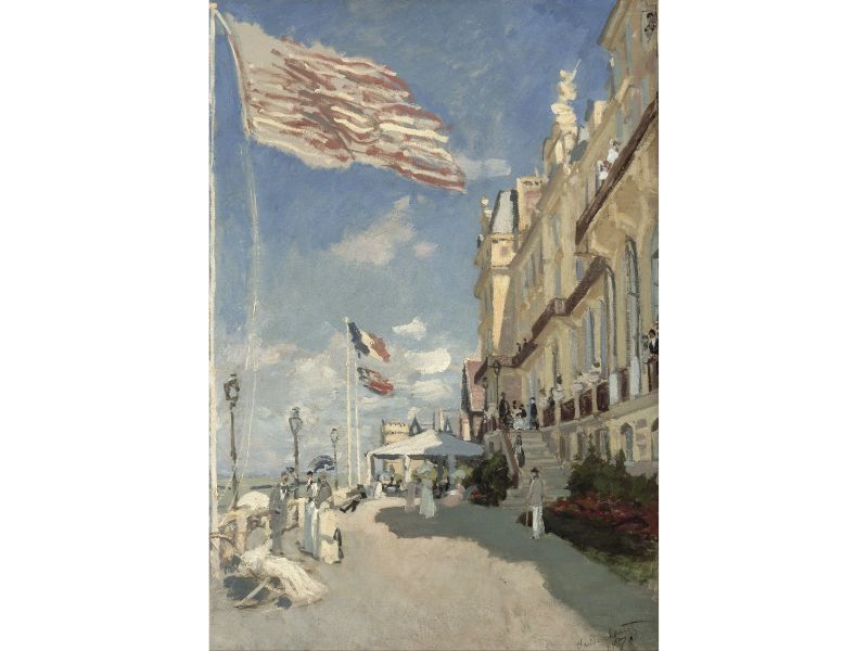 A painting featuring a street scene with the Hotel des roches noires in the background, adorned with a flag and decorative elements, typical of Impressionist style.
