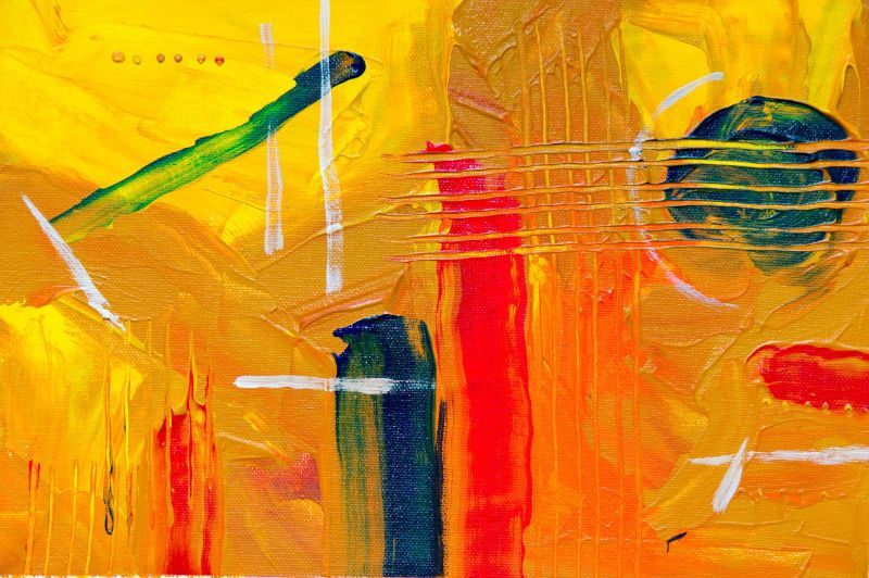 A modern abstract artwork featuring a guitar and vibrant colors such as red, orange, and yellow on a yellow background.